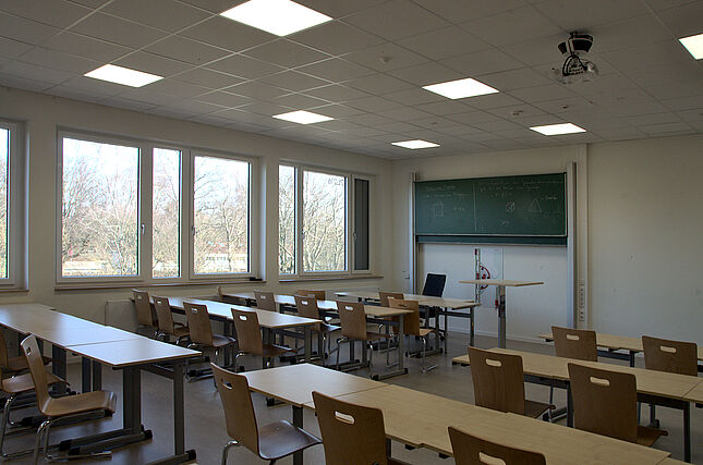 Blick in einen Klassenraum zur Tafel hin.